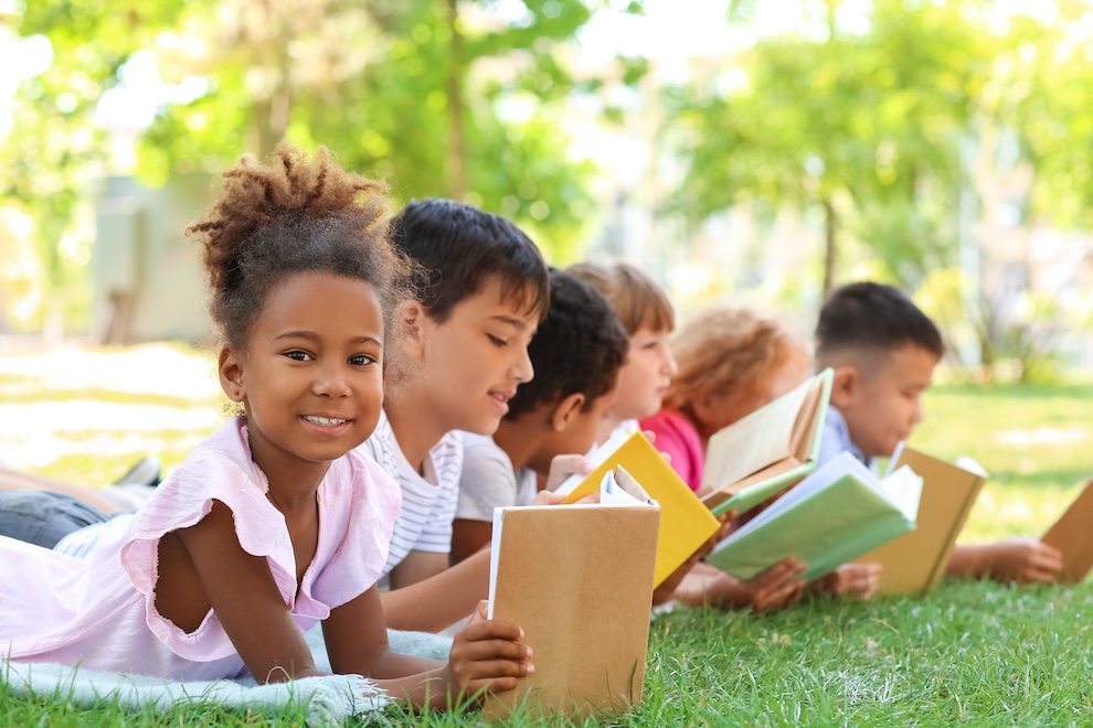 Children reading outside.